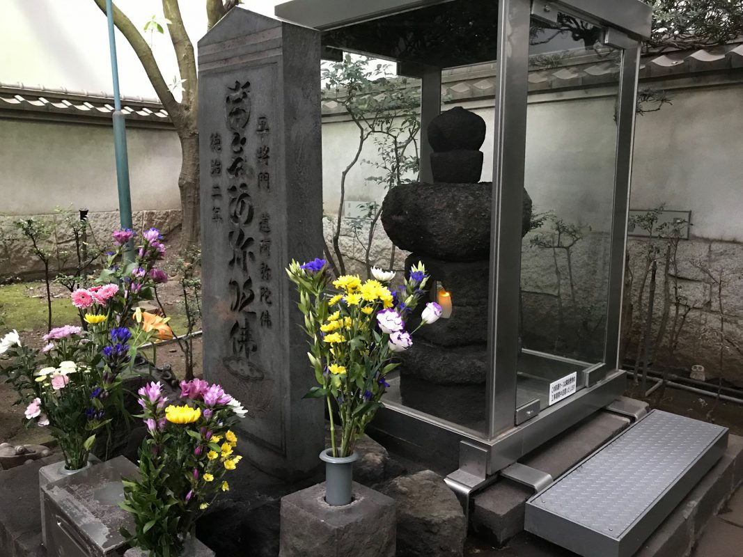 The original memorial protected by glass.